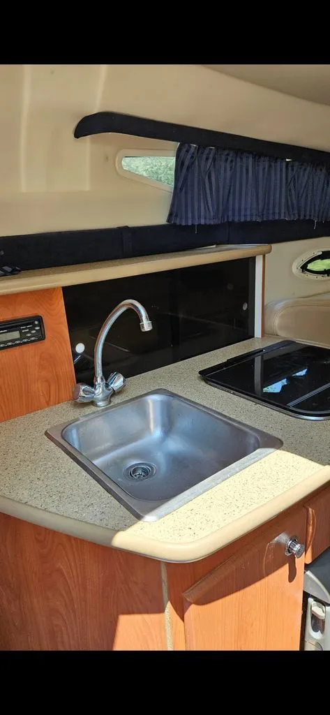 Slide: The Image of Interior of 2006 Bayliner 265 featuring sink and stove. - 3