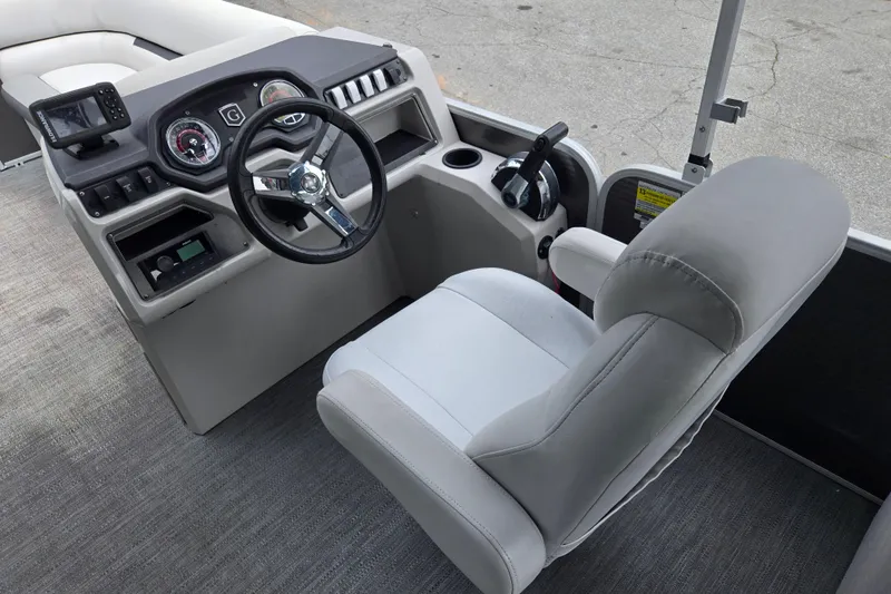 Slide: The Image of 2023 Godfrey Sweetwater 2286 C boat helm with steering wheel and control panel. - 16