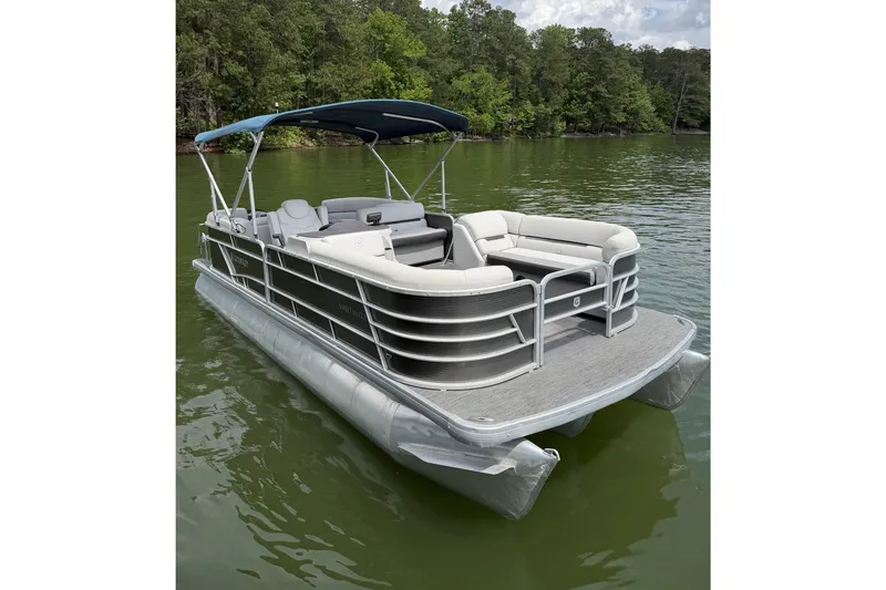 Slide: The Image of 2023 Godfrey Sweetwater 2286 C pontoon boat on a serene lake. - 7