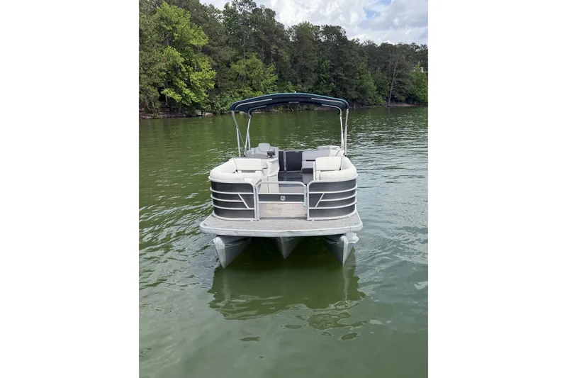 Slide: The Image of 2023 Godfrey Sweetwater 2286 C pontoon boat on a serene lake. - 8
