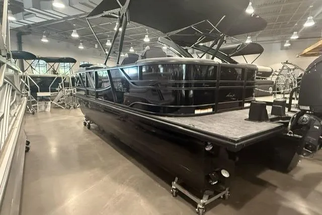 Slide: The Image of 2026 SunCatcher Elite 322SR pontoon boat displayed in a showroom. - 2