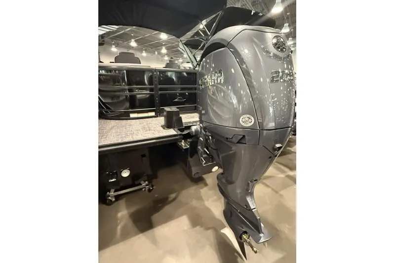 Slide: The Image of 2026 SunCatcher Elite 322SR boat with Yamaha outboard motor in showroom. - 3