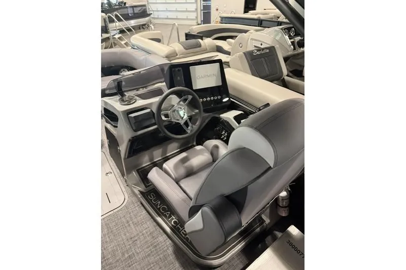 Slide: The Image of Interior of 2026 SunCatcher Elite 322SR boat with modern steering and Garmin display. - 9