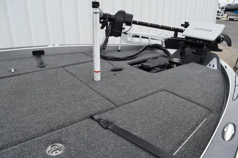 Slide: The Image of 2027 Caymas 201 Pro boat deck with Garmin equipment and carpeted surface. - 12