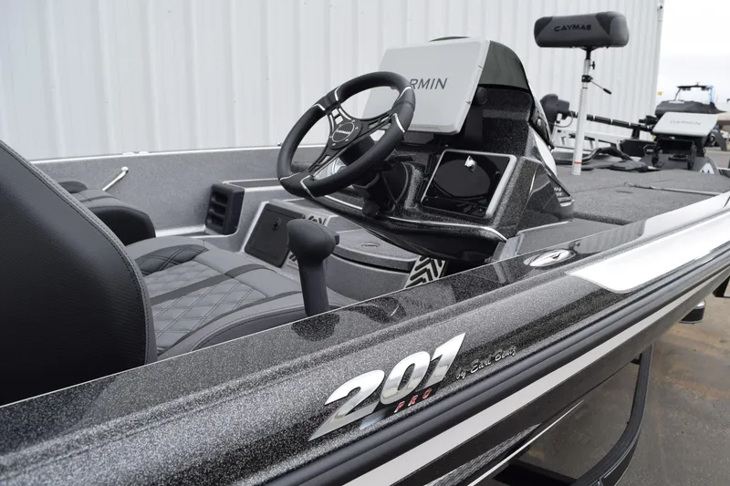 Slide: The Image of 2027 Caymas 201 Pro boat interior with steering wheel and Garmin display. - 13