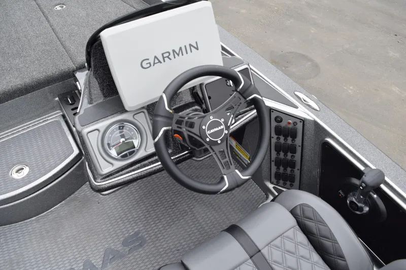 Slide: The Image of Cockpit of 2027 Caymas 201 Pro boat with Garmin display and steering wheel. - 18