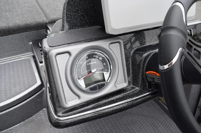 Slide: The Image of Dashboard of 2027 Caymas 201 Pro boat featuring a sleek gauge and steering wheel. - 22