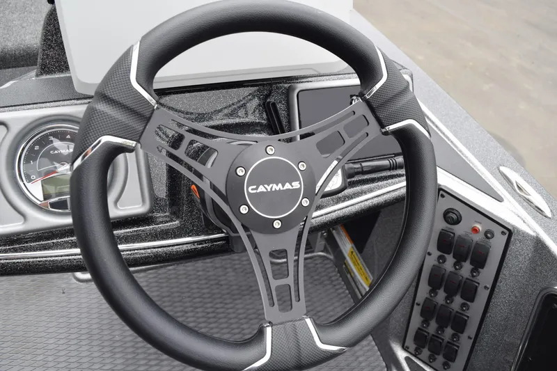 Slide: The Image of Steering wheel of 2027 Caymas 201 Pro boat with dashboard controls. - 23