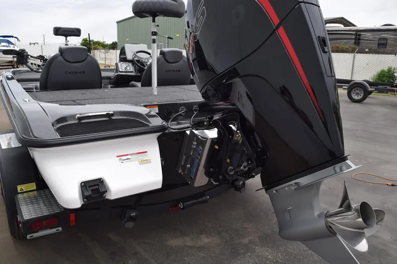 Slide: The Image of 2027 Caymas 201 Pro boat with powerful outboard motor, sleek design, and comfortable seating. - 26