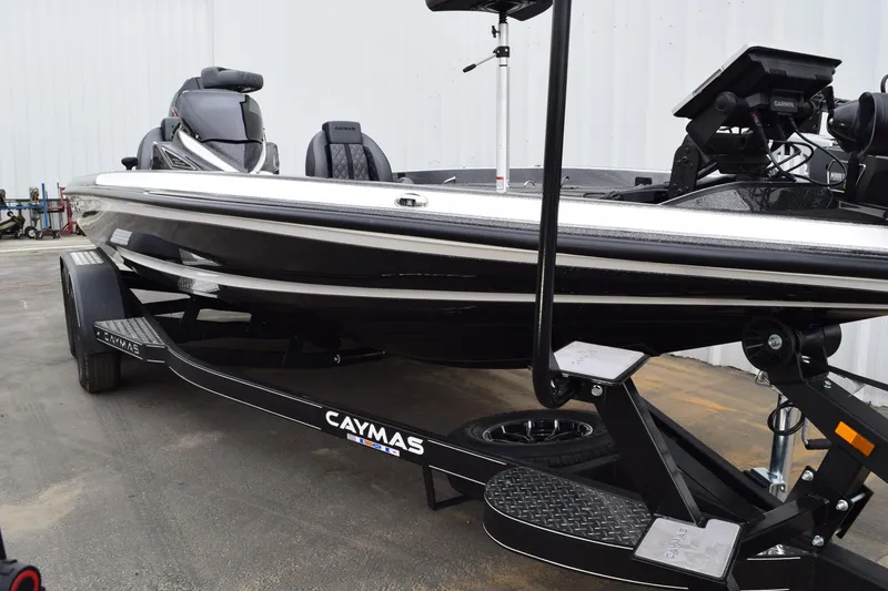 Slide: The Image of 2027 Caymas 201 Pro boat on trailer, featuring sleek black design and advanced equipment. - 3