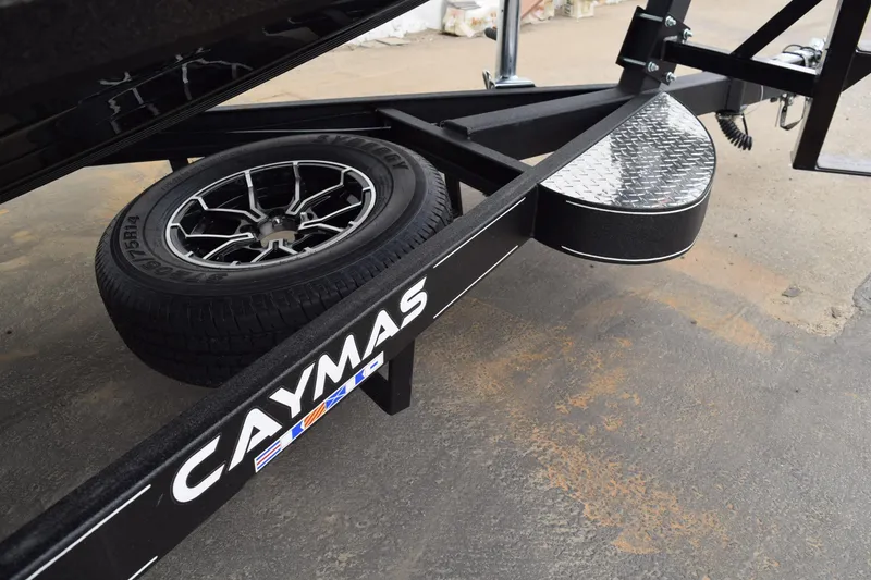 Slide: The Image of Trailer of 2027 Caymas 201 Pro boat with spare tire and diamond plate step. - 34