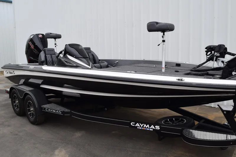 Slide: The Image of 2027 Caymas 201 Pro bass boat on trailer, sleek design, dual seats, powerful engine. - 6