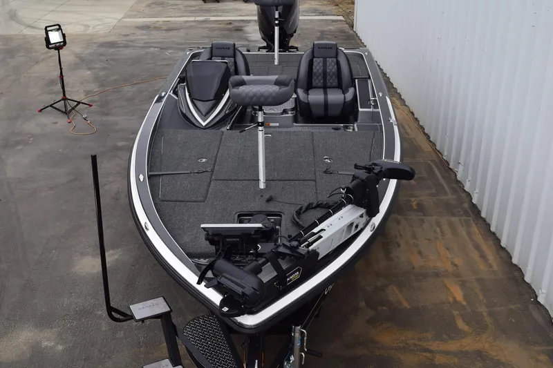 Slide: The Image of 2027 Caymas 201 Pro fishing boat with advanced equipment and seating, docked outdoors. - 8