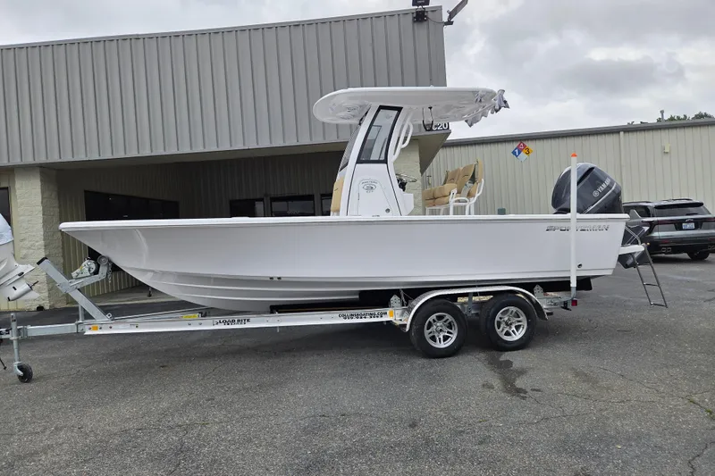 The Image of 2026 Sportsman Masters 227 Bay Boat on trailer, parked outside a building. - 0