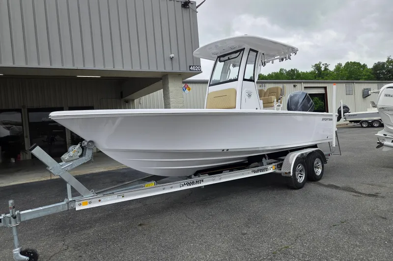 Slide: The Image of 2026 Sportsman Masters 227 Bay Boat on trailer outside dealership. - 1