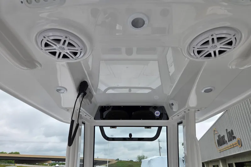 Slide: The Image of Ceiling view of 2026 Sportsman Masters 227 Bay Boat with speakers and microphone. - 12