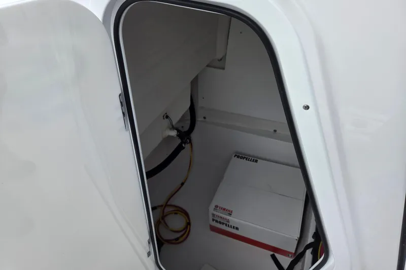 Slide: The Image of Storage compartment of 2026 Sportsman Masters 227 Bay Boat with Yamaha propeller box. - 13