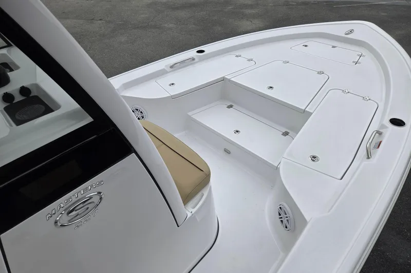 Slide: The Image of 2026 Sportsman Masters 227 Bay Boat interior with storage compartments and seating. - 14