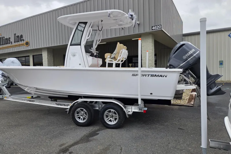 Slide: The Image of 2026 Sportsman Masters 227 Bay Boat on trailer, parked outside a building. - 2