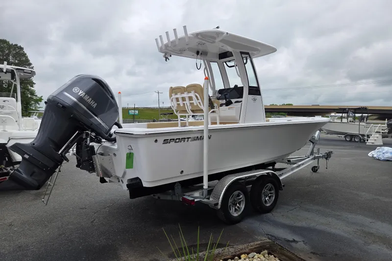 Slide: The Image of 2026 Sportsman Masters 227 Bay Boat with Yamaha engine on trailer, parked outdoors. - 3