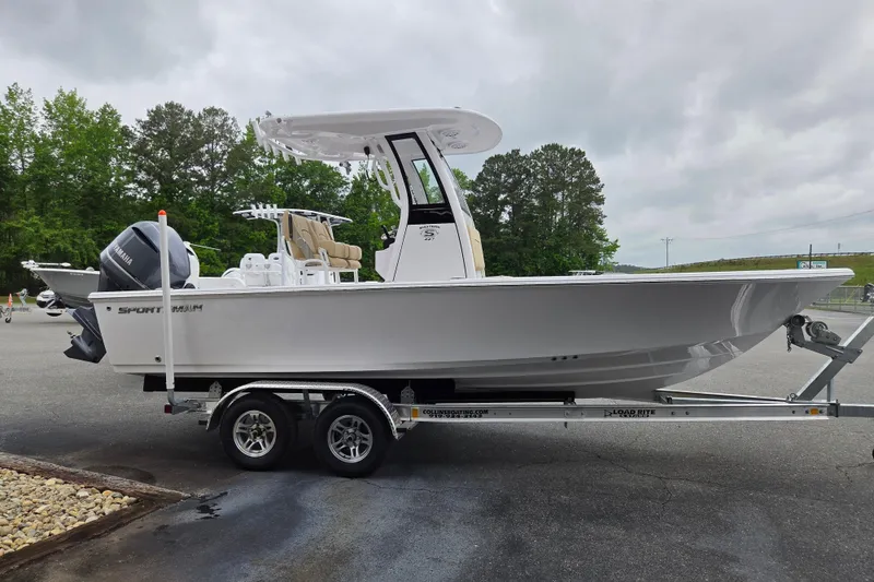 Slide: The Image of 2026 Sportsman Masters 227 Bay Boat on trailer, parked outdoors, side view. - 4