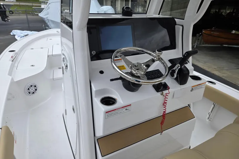 Slide: The Image of 2026 Sportsman Masters 227 Bay Boat cockpit with steering wheel and control panel. - 7