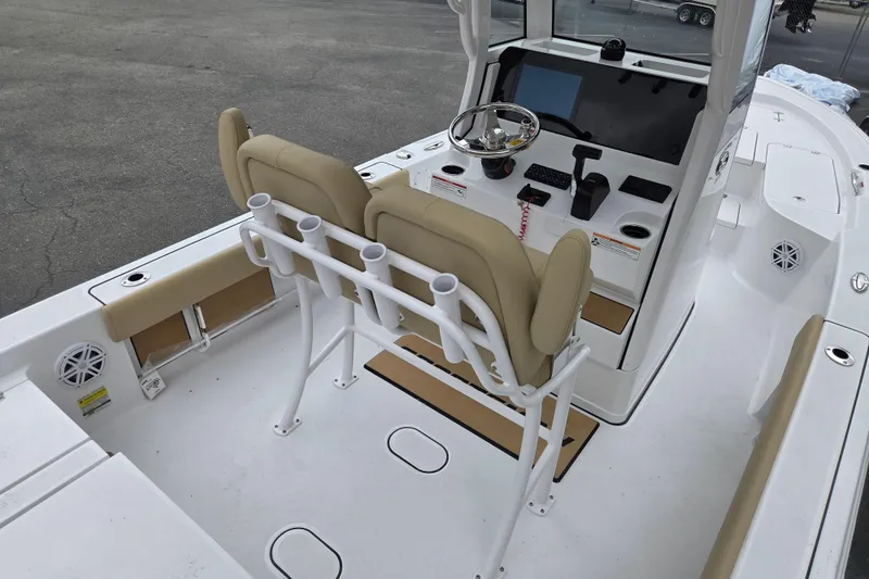 Slide: The Image of 2026 Sportsman Masters 227 Bay Boat interior with helm, seating, and rod holders. - 8