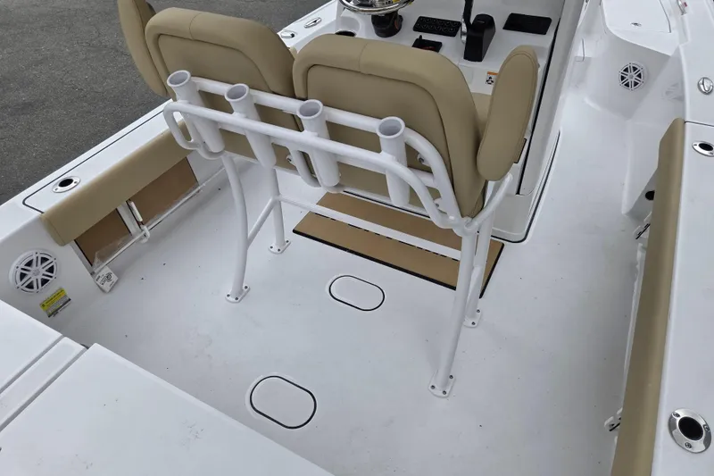 Slide: The Image of Interior of 2026 Sportsman Masters 227 Bay Boat with beige seating and rod holders. - 9