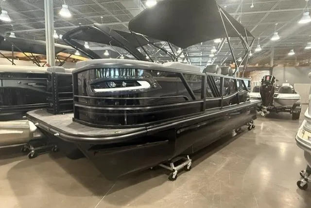 The Image of 2026 SunCatcher Elite 322SR pontoon boat displayed indoors with sleek black design. - 1