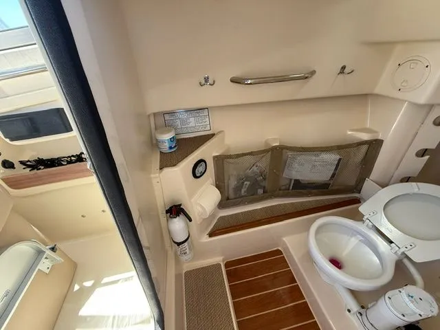 Slide: The Image of Interior of 2013 Grady-White Freedom 285 with toilet and storage. - 15
