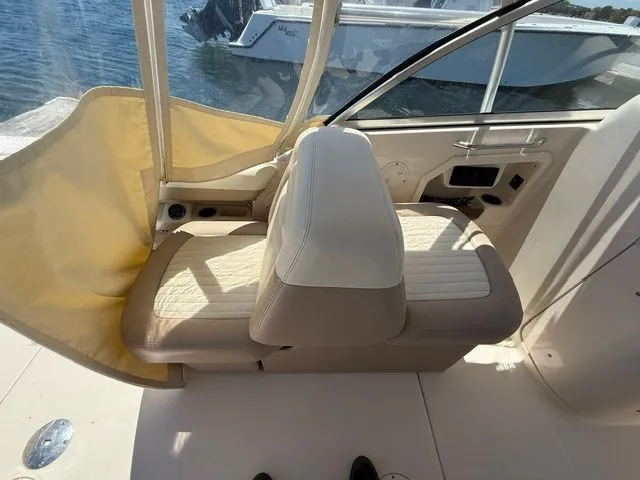 Slide: The Image of Interior of a 2013 Grady-White Freedom 285 boat with beige seating. - 20