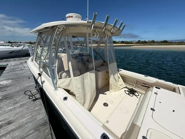 Slide: The Image of 2013 Grady-White Freedom 285 boat docked on a sunny day. - 5
