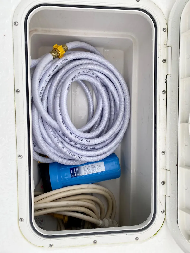 Slide: The Image of Storage compartment in Back Cove 37 boat with hoses, 2017 model. - 13
