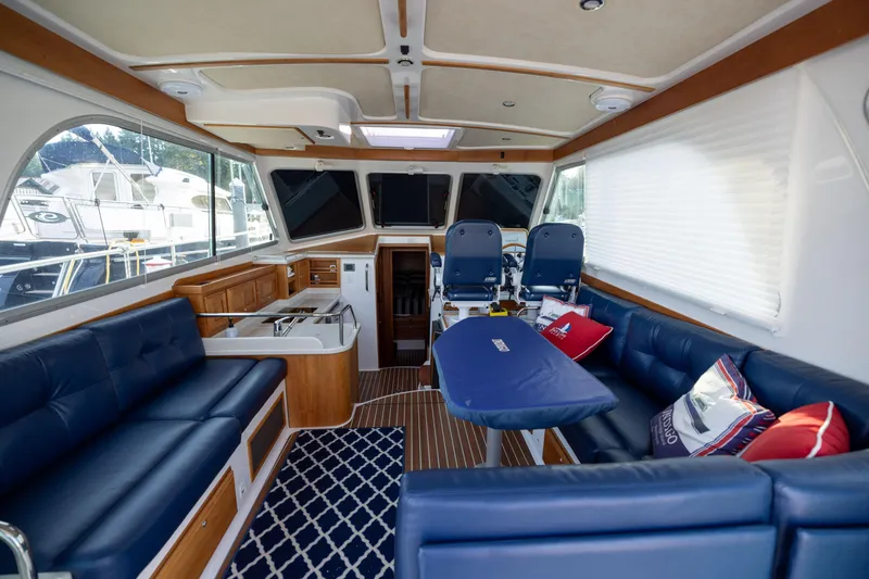 Slide: The Image of Interior of a 2017 Back Cove 37 yacht with blue seating and wood accents. - 19