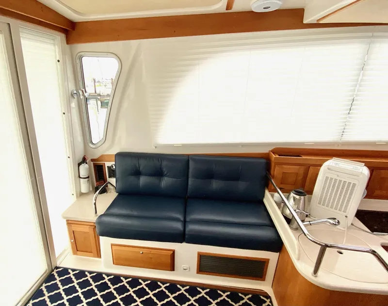 Slide: The Image of Interior of a 2017 Back Cove 37 yacht with blue leather couch. - 25