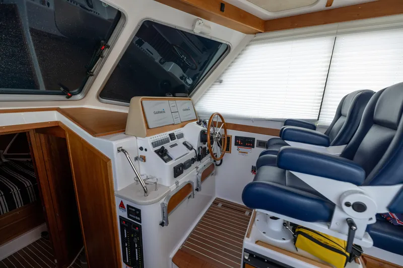 Slide: The Image of Interior of 2017 Back Cove 37 yacht with helm station and blue seats. - 27