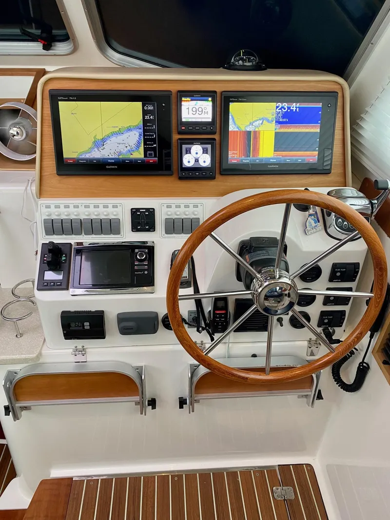 Slide: The Image of Back Cove 37 yacht helm, 2017 model, featuring advanced navigation systems. - 29