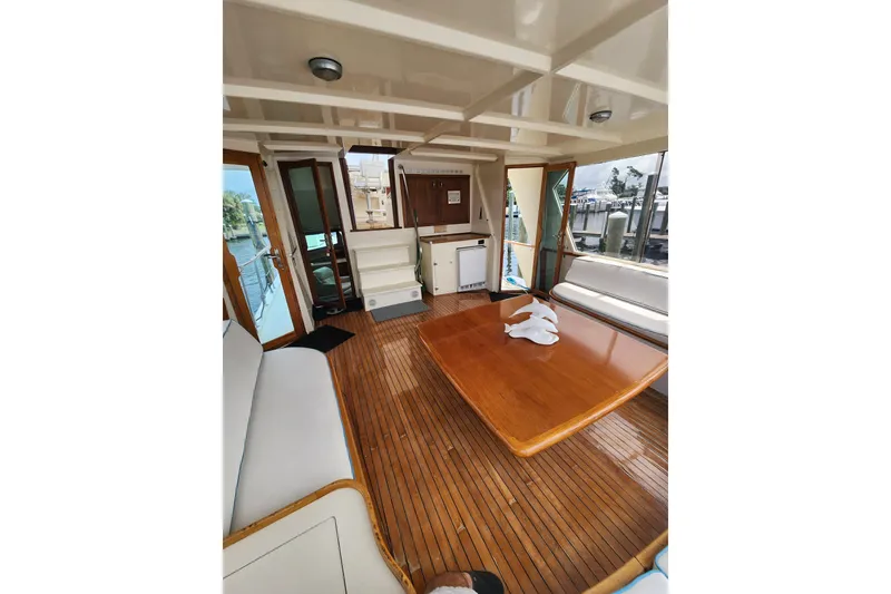 Slide: The Image of Interior of 1983 Hatteras 48 Motor Yacht with wooden flooring and seating area. - 11