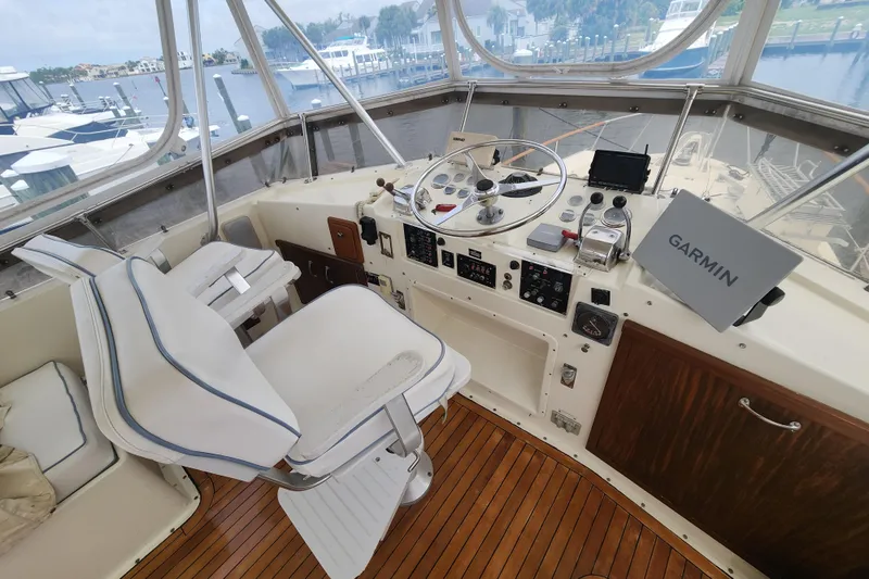 Slide: The Image of Cockpit of 1983 Hatteras 48 Motor Yacht with Garmin navigation system and wooden flooring. - 16