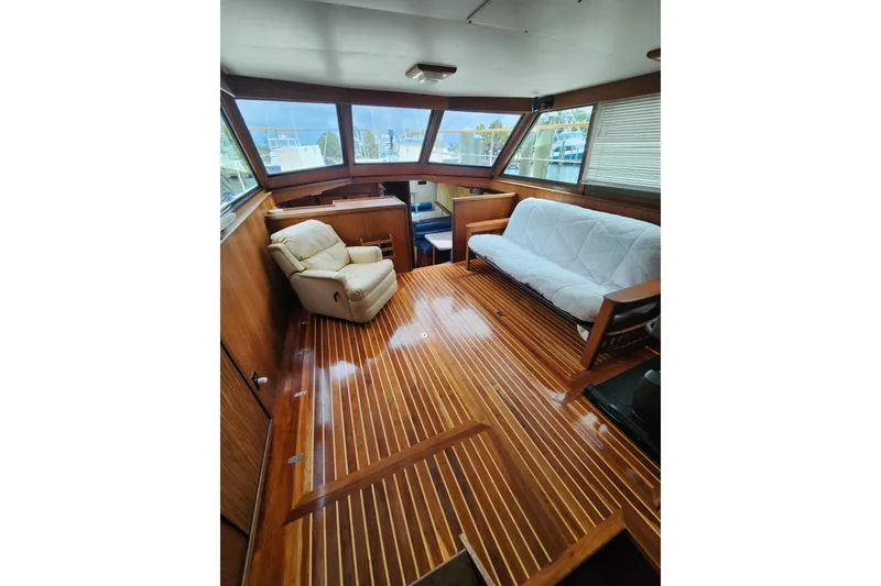 Slide: The Image of Interior of 1983 Hatteras 48 Motor Yacht with wooden flooring, recliner, and sofa. - 18