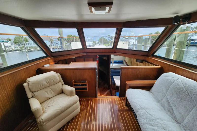 Slide: The Image of Interior of 1983 Hatteras 48 Motor Yacht with wood paneling and comfortable seating. - 19