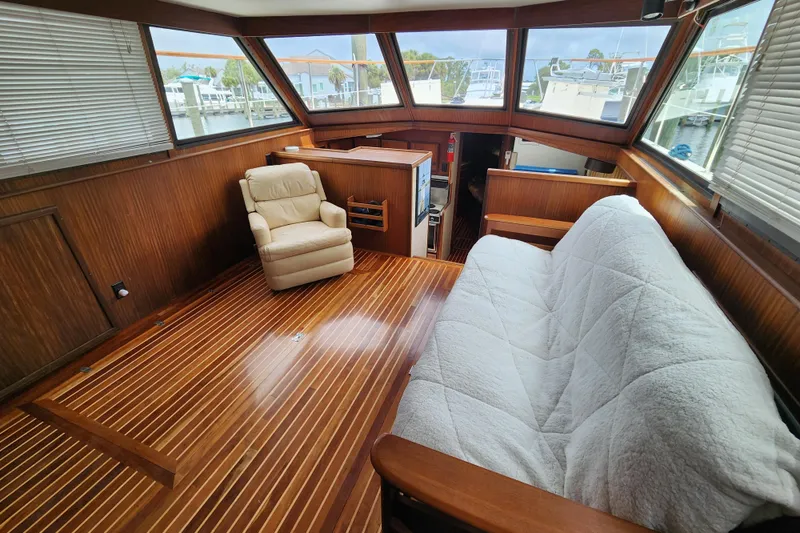 Slide: The Image of Interior of 1983 Hatteras 48 Motor Yacht with wood paneling and comfortable seating. - 20