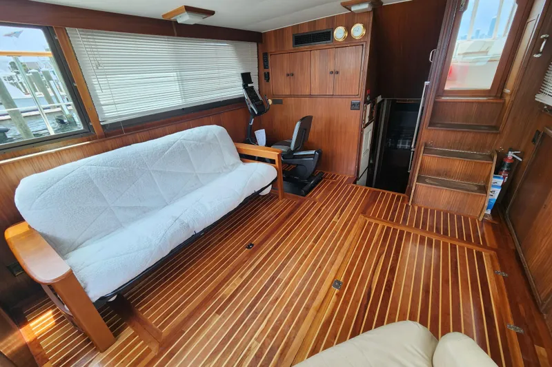 Slide: The Image of Interior of 1983 Hatteras 48 Motor Yacht with wooden flooring and seating area. - 21