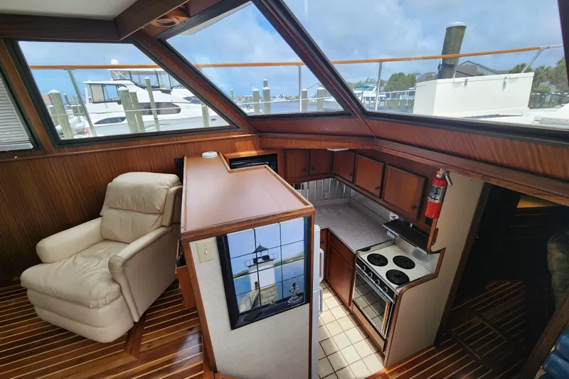 Slide: The Image of Interior of 1983 Hatteras 48 Motor Yacht with kitchen and seating area. - 23