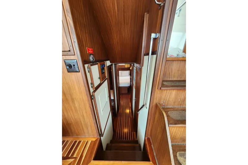Slide: The Image of Interior view of 1983 Hatteras 48 Motor Yacht with wooden paneling and narrow hallway. - 25