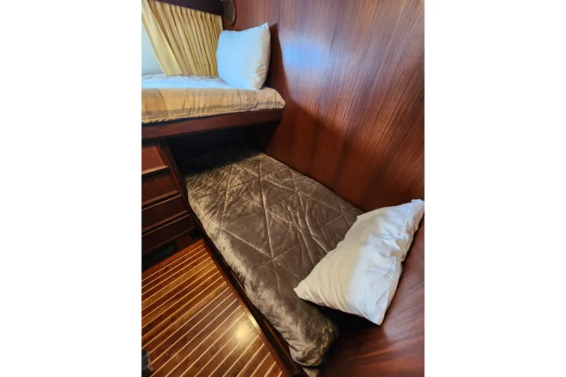 Slide: The Image of Interior cabin of 1983 Hatteras 48 Motor Yacht with bunk beds and wood paneling. - 28