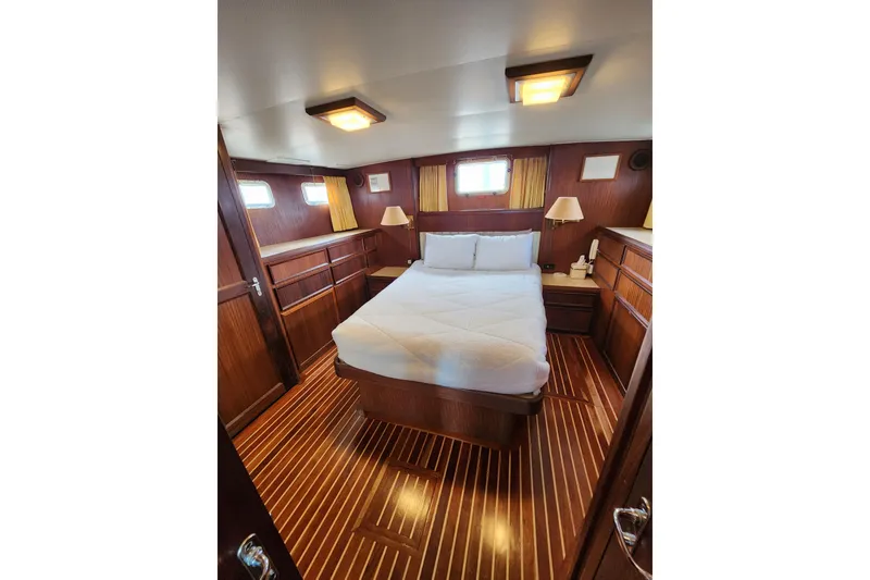 Slide: The Image of Interior of 1983 Hatteras 48 Motor Yacht with wood paneling and cozy bed. - 31