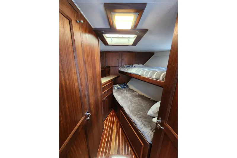 Slide: The Image of 1983 Hatteras 48 Motor Yacht cabin with wooden interior and bunk beds. - 35