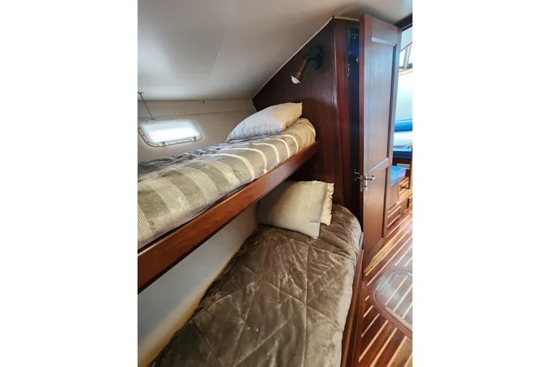 Slide: The Image of Cozy bunk beds in 1983 Hatteras 48 Motor Yacht cabin with wooden interior. - 37