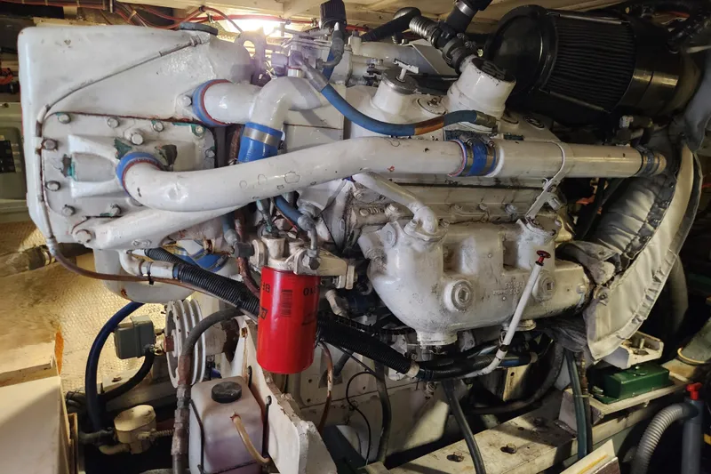 Slide: The Image of Engine room of a 1983 Hatteras 48 Motor Yacht, showcasing detailed machinery. - 39